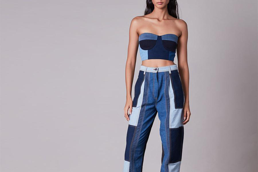 Woman wearing a denim patchwork crop top and pants