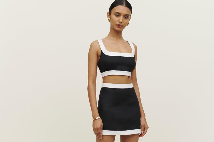 Woman wearing a white and black miniskirt set