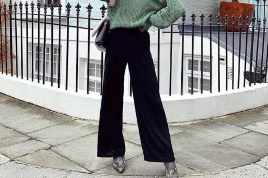 Woman wearing black wide-leg trousers