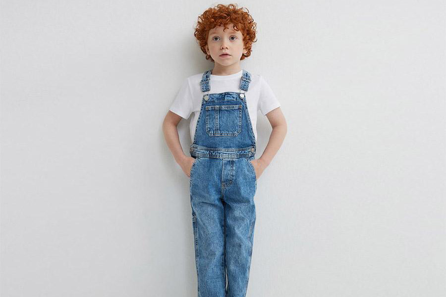 Young boy wearing blue suspender jeans