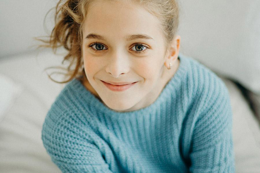 Young girl wearing a light blue sweater