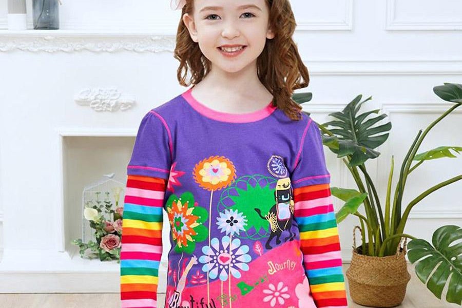 Young girl wearing a rainbow-colored layered T-shirtYoung girl wearing a rainbow-colored layered T-shirt