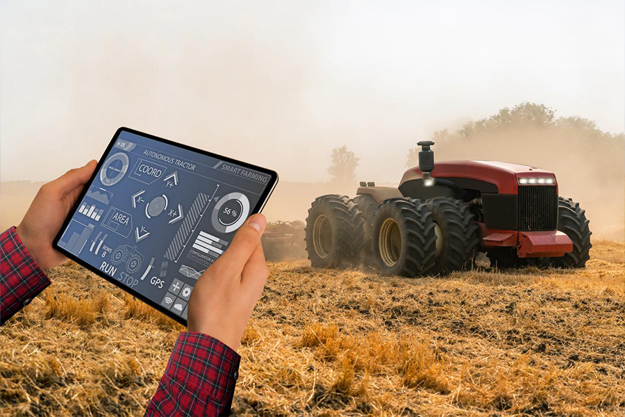 A farmer monitoring the tractor operation on a tablet