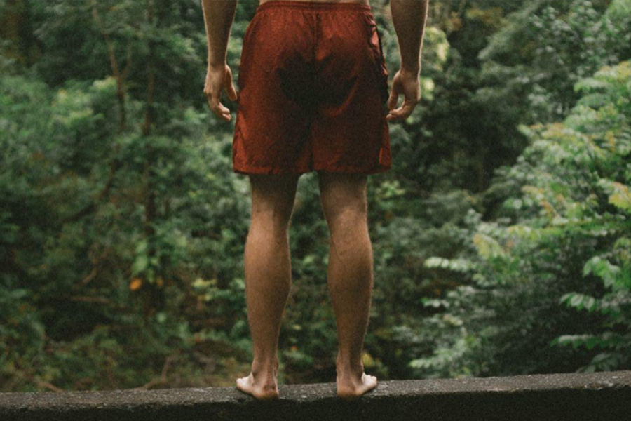 A man wearing red color shorts