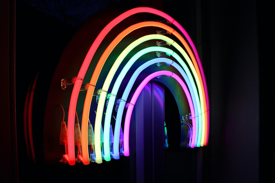 A rainbow shaped neon sign
