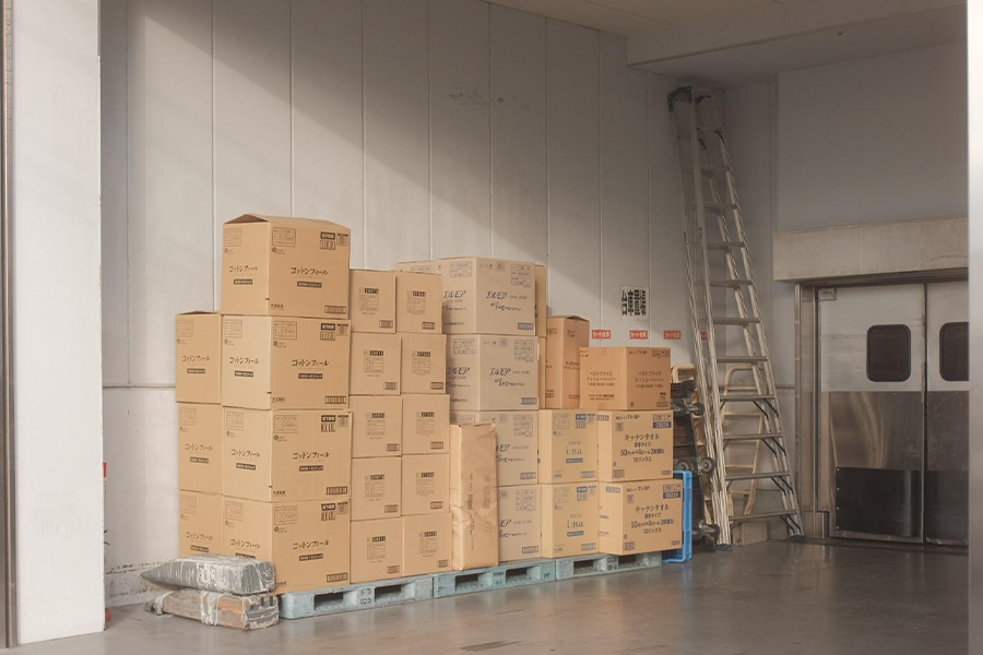 A warehouse containing some inventory and a ladder 