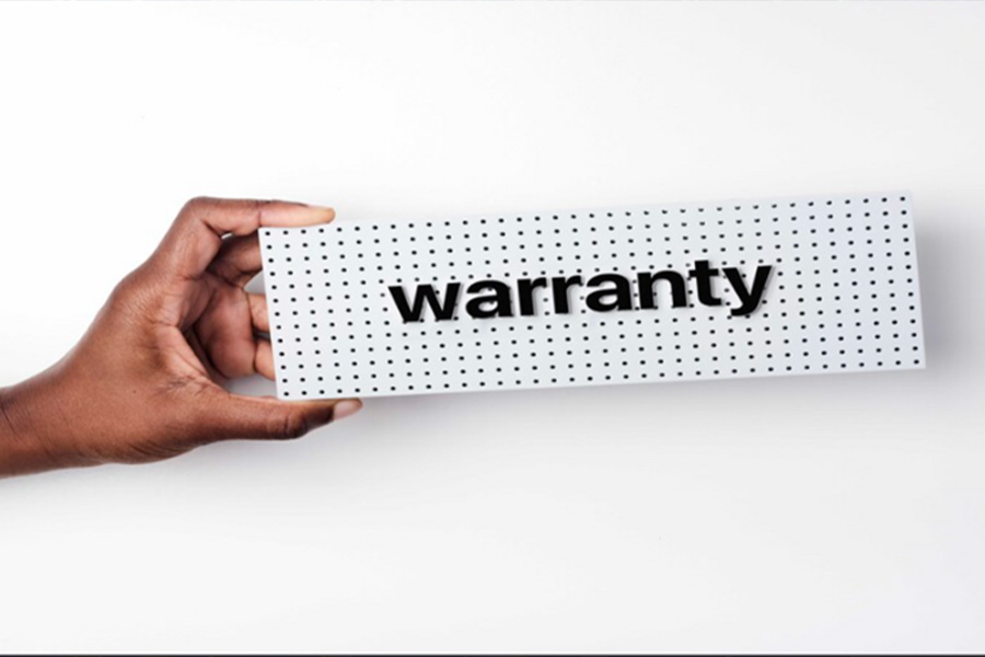 A warranty card held over a white background