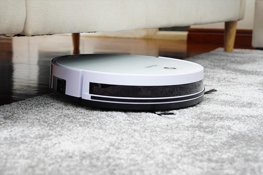 A white robot vacuum cleaner