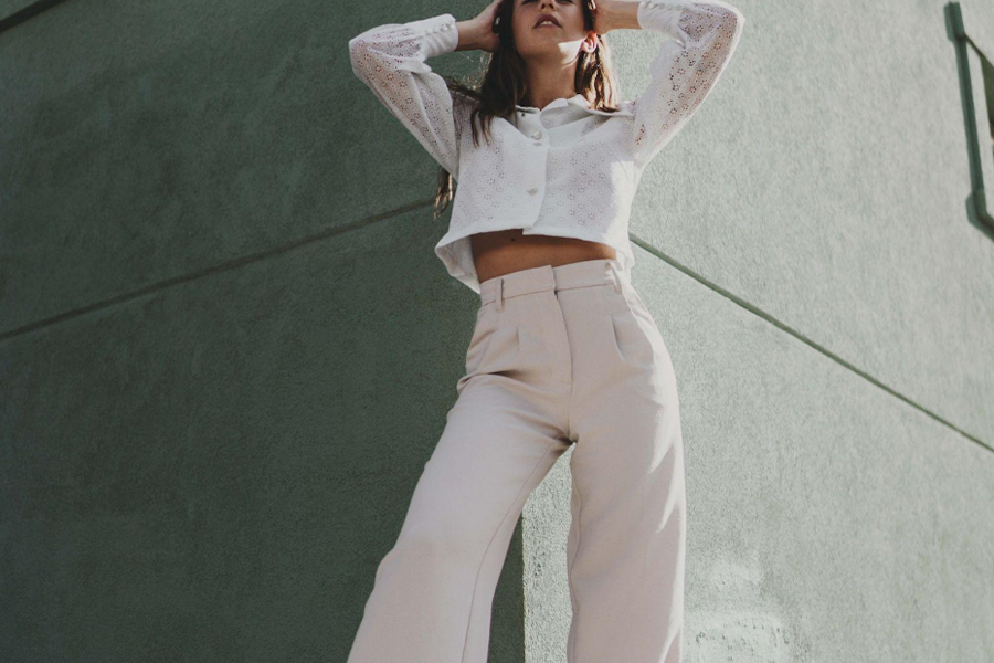 A woman wearing a beige top and pants