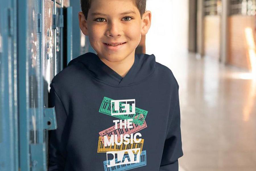 Boy by a school locker wearing a t-shirt hoodie
