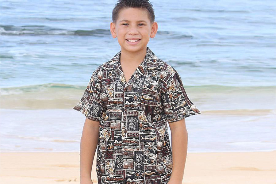 Boy on the beach wearing a resort shirt
