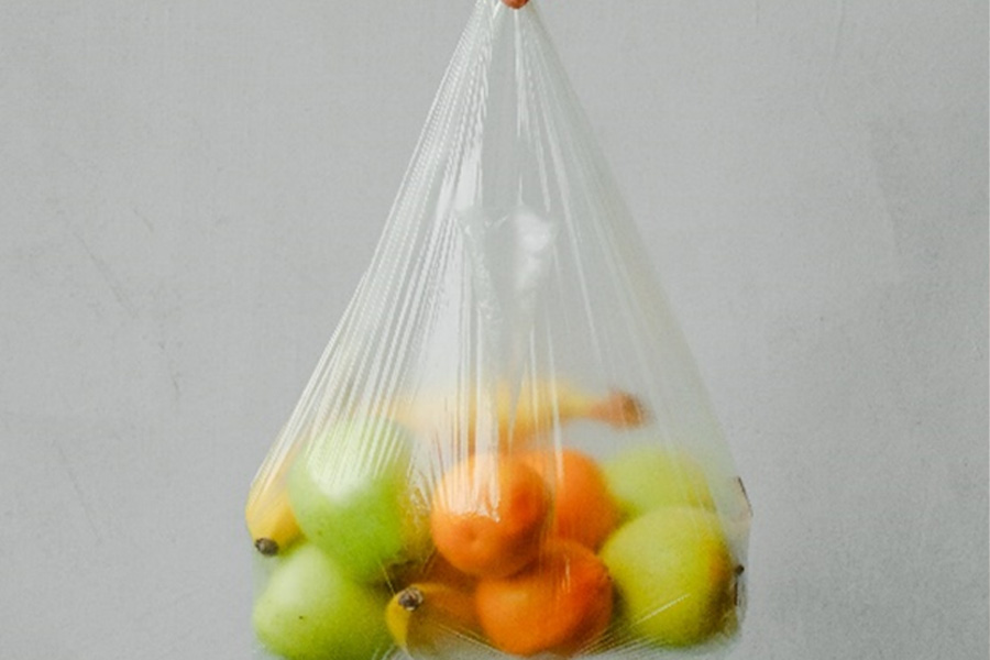 Clear plastic grocery bag with fruit inside