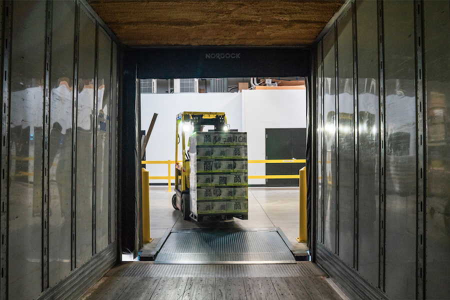 forklift loading a palletized shipment into a container