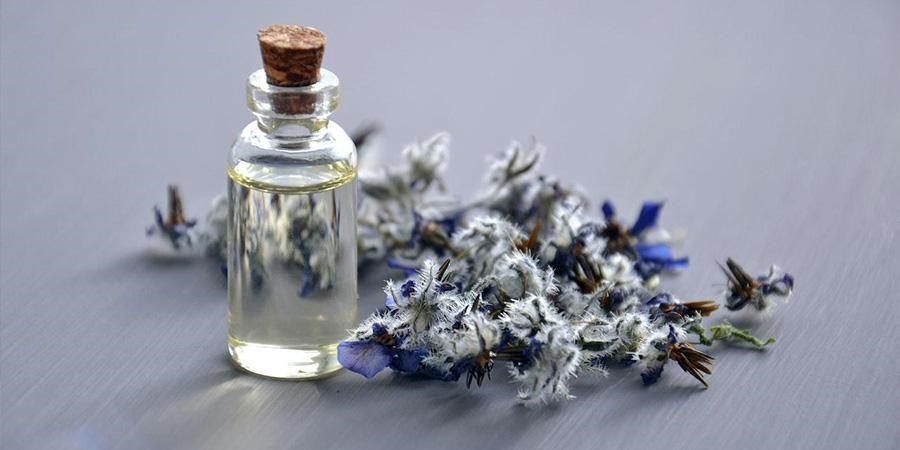 Fragrance bottle beside flowers