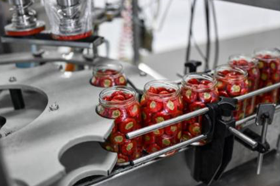 Fruits being caned by a canning machine