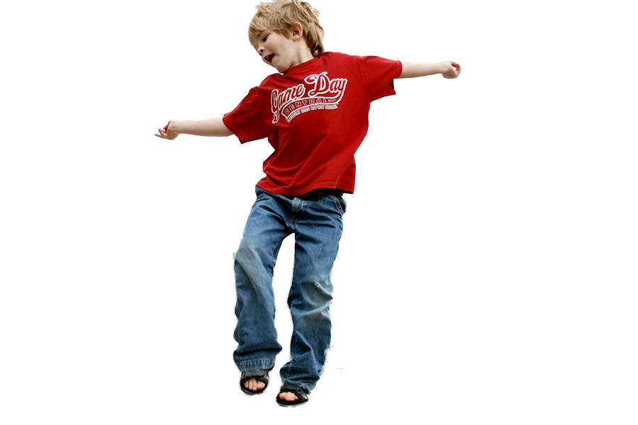 Kid jumping with a red graphic tee