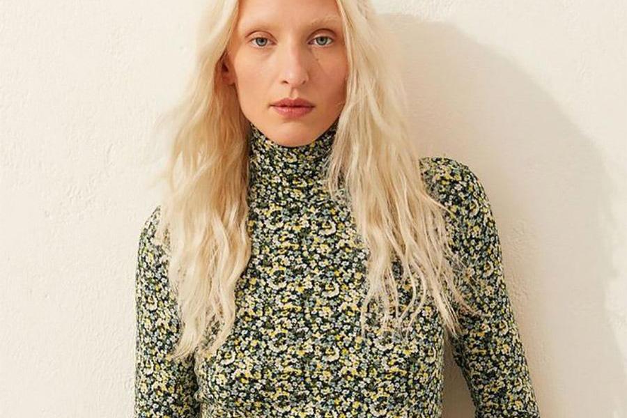 Lady in a green floral roll-neck top