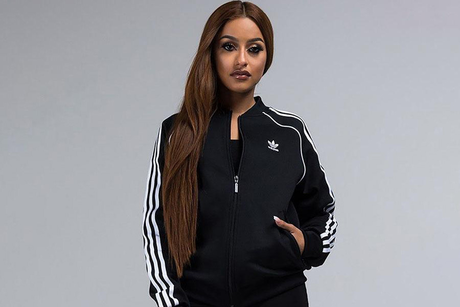 A lady wearing a black tracksuit