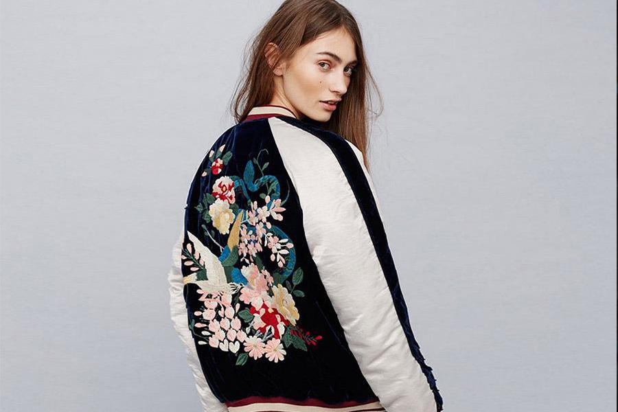 Lady wearing a floral embrioded bomber jacket