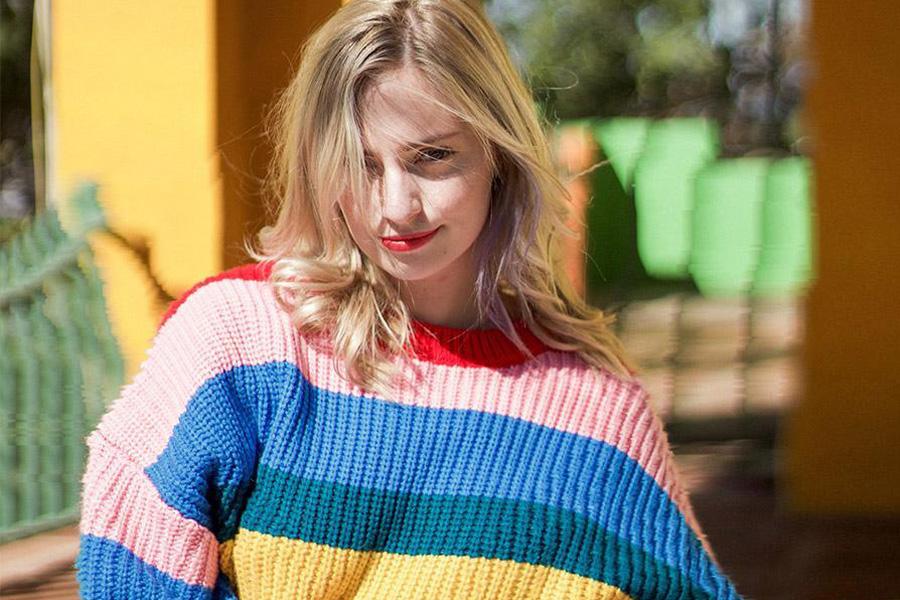 Lady wearing a multi-colored panel sweater