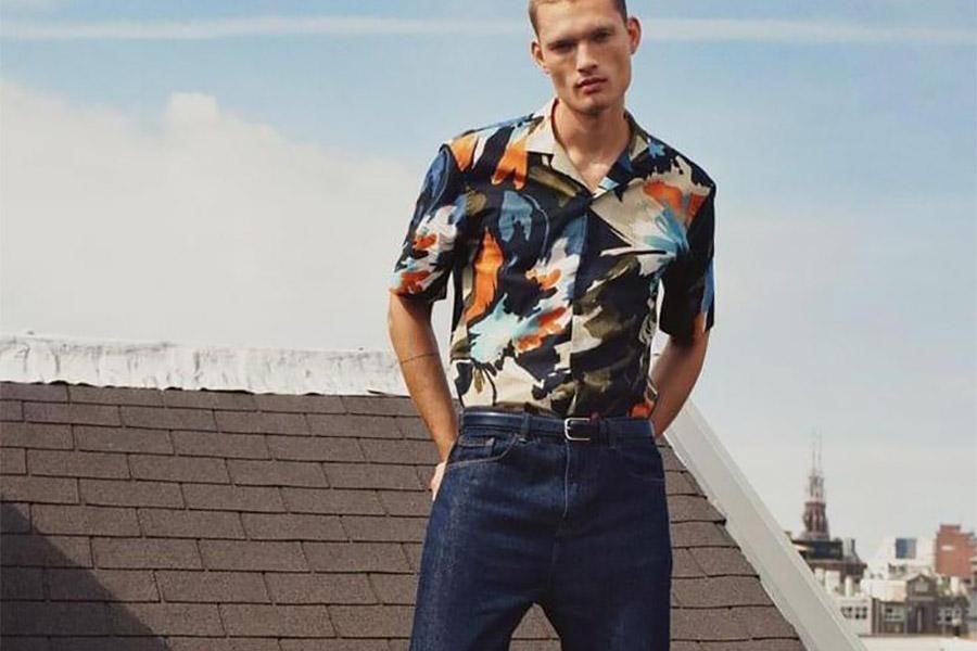 Man on a roof rocking an abstract designed short-sleeve