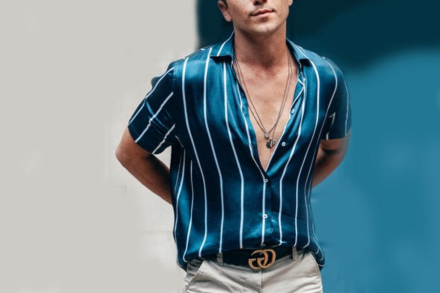 Man posing with blue stripped slick shirt