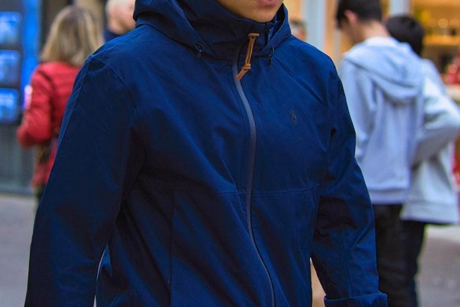 Man wearing a blue zipped-up jacket