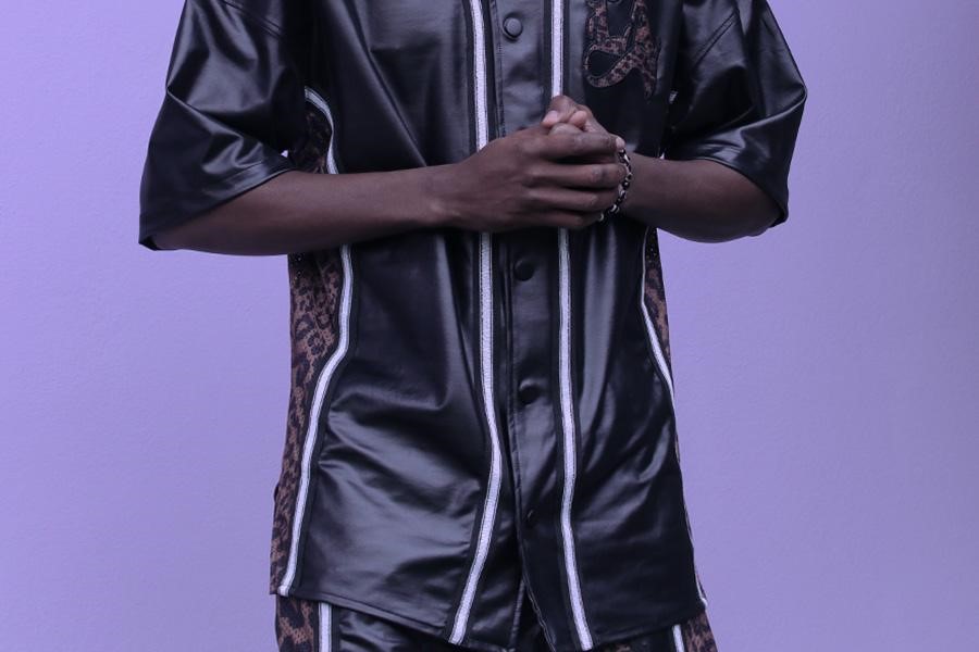Man wearing matching black set with patterns