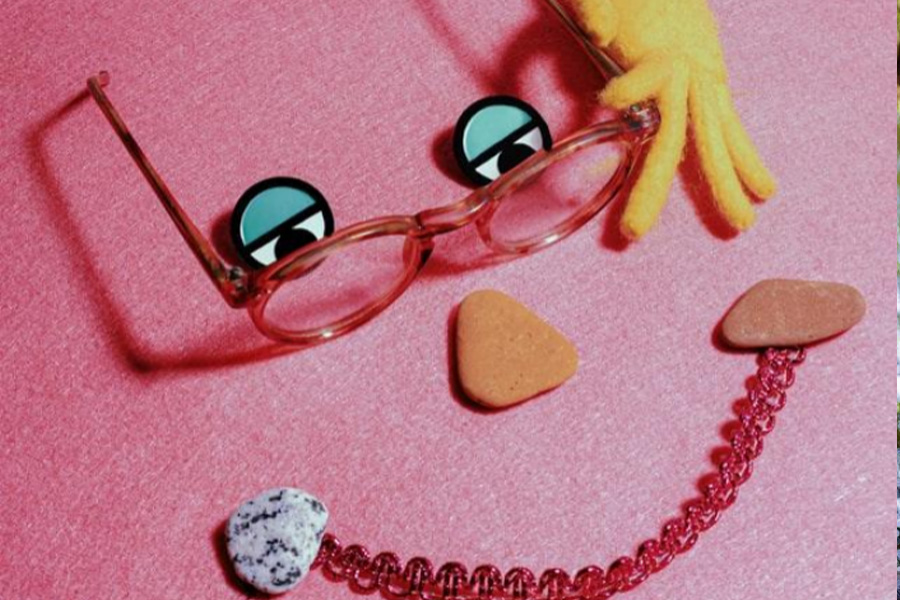 pair of glasses placed on a pink sheet