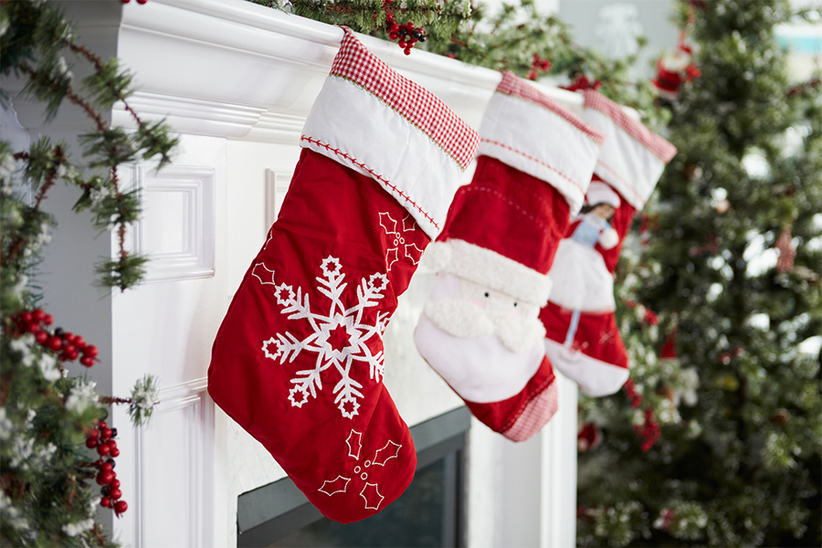 Set of Christmas stockings hanging over a fireplace