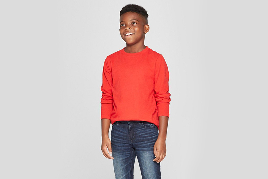 Tween smiling while wearing a red long-sleeved tee