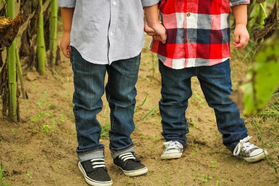 Two young boys wearing vintage-fit denim pants