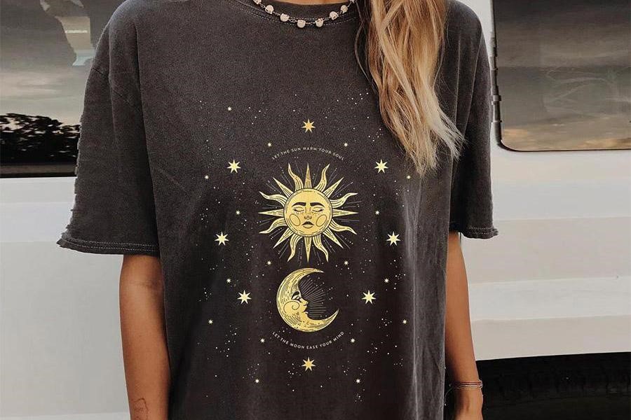 Woman rocking an oversized top with sun and moon design
