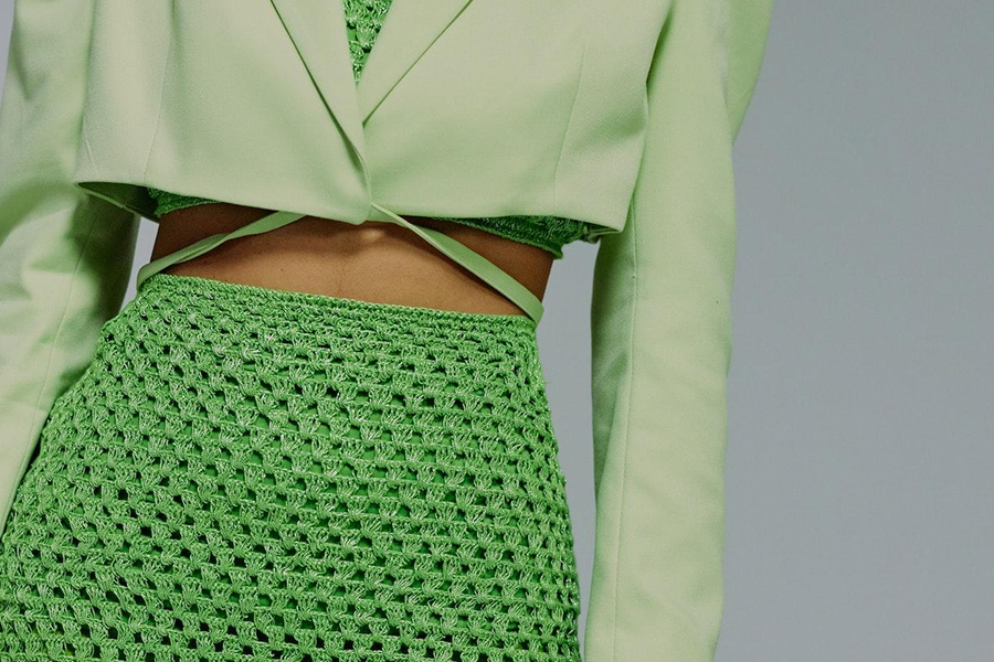 A woman wearing a green skirt and a matching top