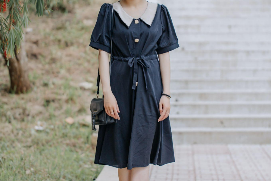 A woman wearing a navy blue color dress