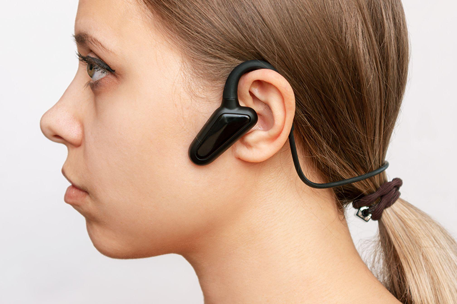 Woman wearing bone-conduction headphones