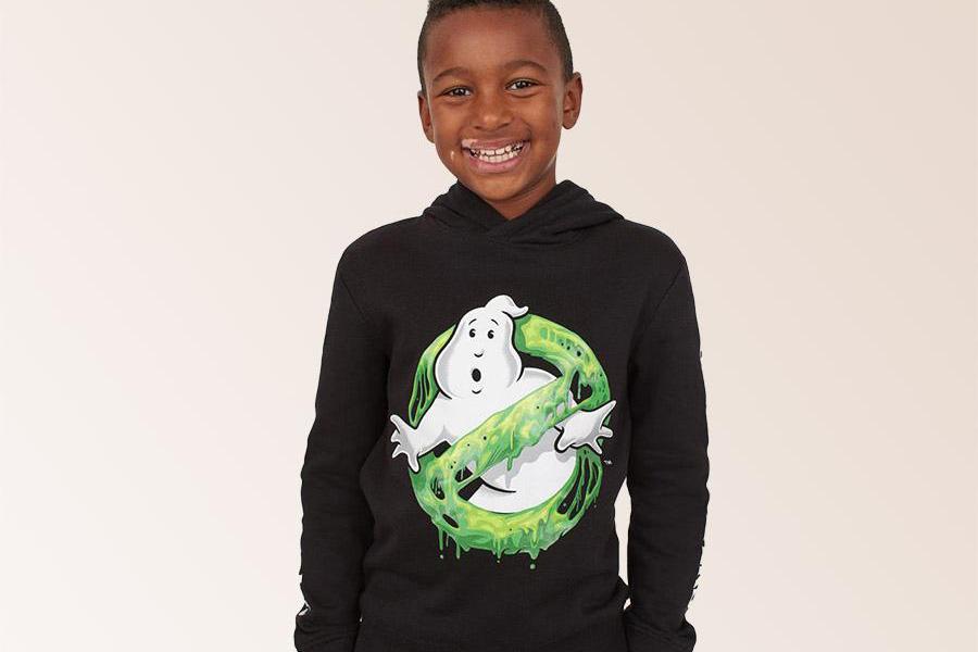 Young boy rocking a t-shirt hoodie with Ghostbusters illustration