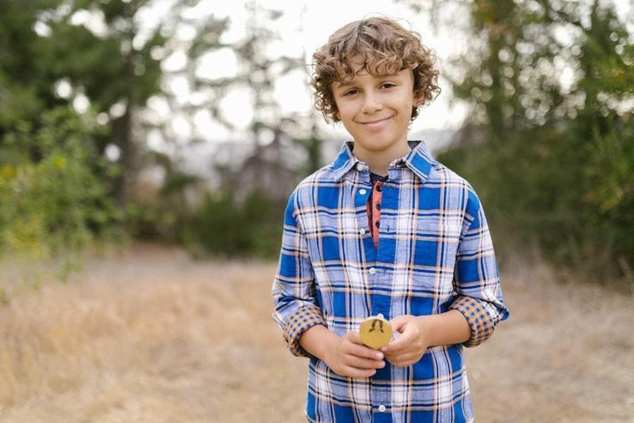 Young boy wearing a blue checkered shirt