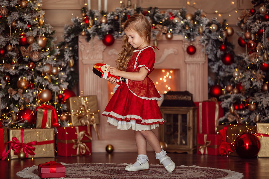 Young girl wearing a Christmas frock