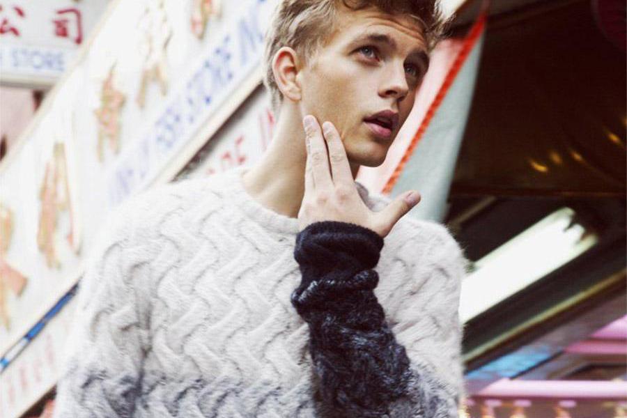Young man rocking a neutral-colored ombre sweater