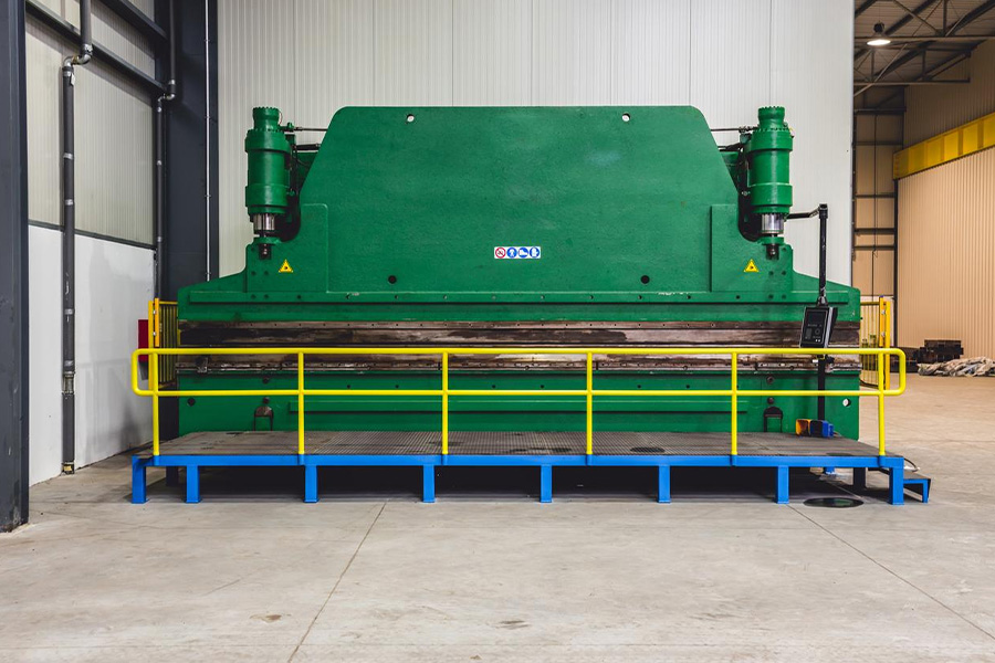A hydraulic sheet metal press brake in a spacious industrial hall