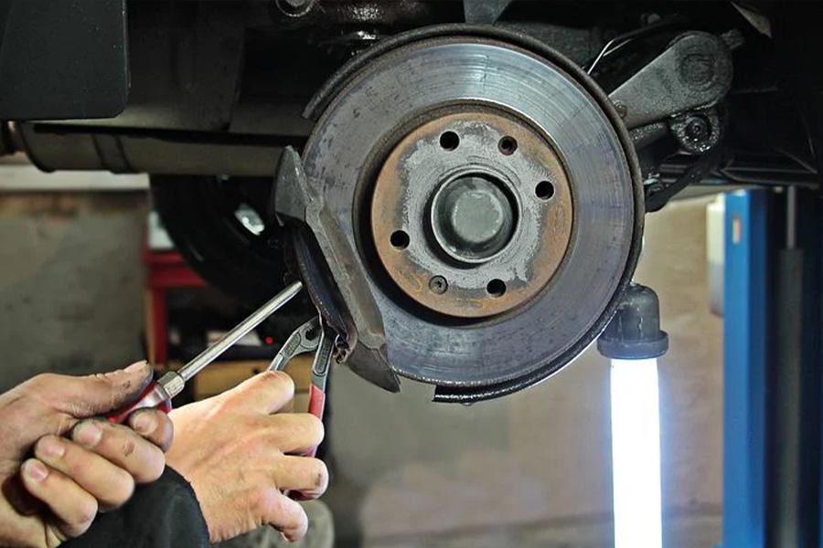 A man removing brake pad