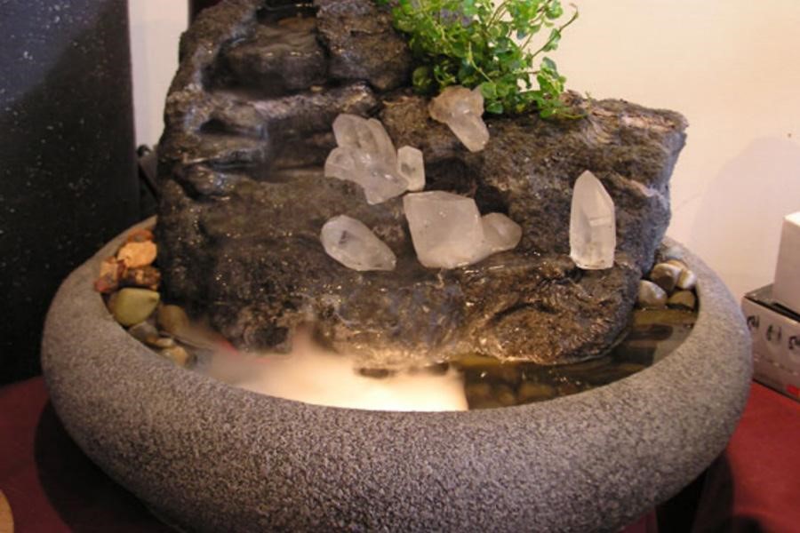 A stoned carved tabletop fountain
