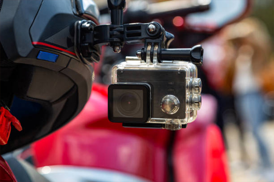 Action camera attached to the side of a motorcycle helmet