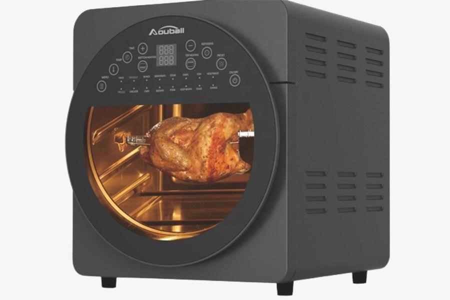 Air fryer oven with chicken on rotisserie