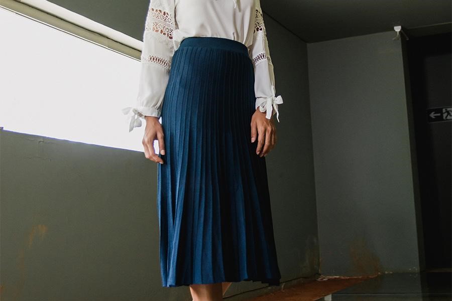 Anonymous woman posing with blue column skirt