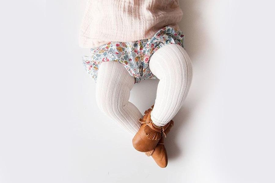 Baby rocking a bloomer with a pair of knit tights