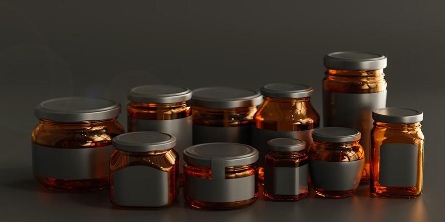 Different sizes of small glass containers for cosmetics and food
