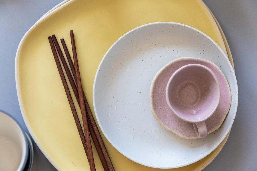 Earthenware dinnerware set on a table with chopsticks