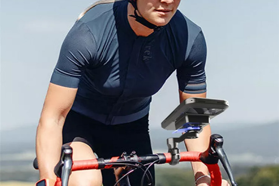 Female cyclist using a wirelessly charging mobile phone holder